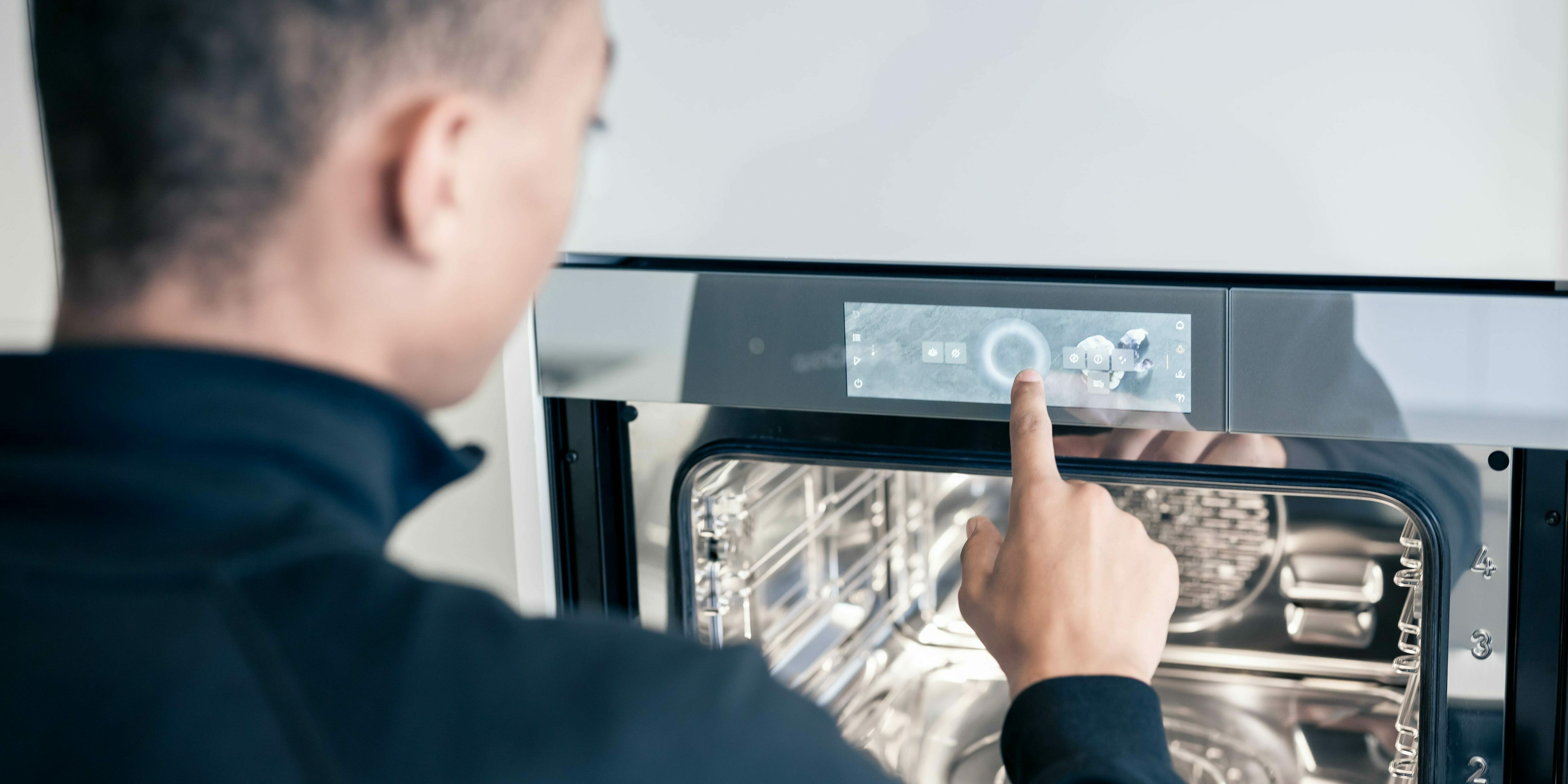 Technician operates oven display